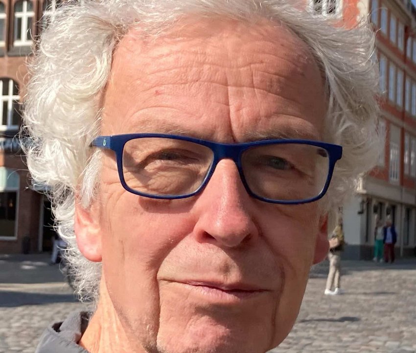 Ein Mann mit Brille und grauen Haaren